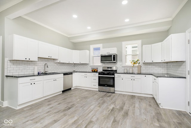 408 W 11th St, Anderson, IN 46016 - kitchen with appliances with stainless steel finishes, a sink, ornamental molding, dark countertops, and decorative backsplash