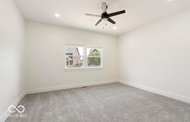 spare room with carpet and ceiling fan