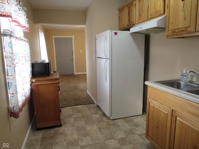 kitchen with butcher block countertops, light colored carpet, sink, and white refrigerator