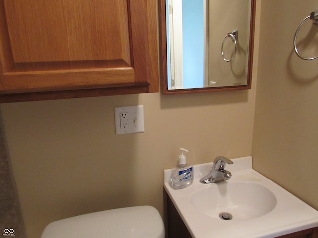 bathroom with toilet and vanity