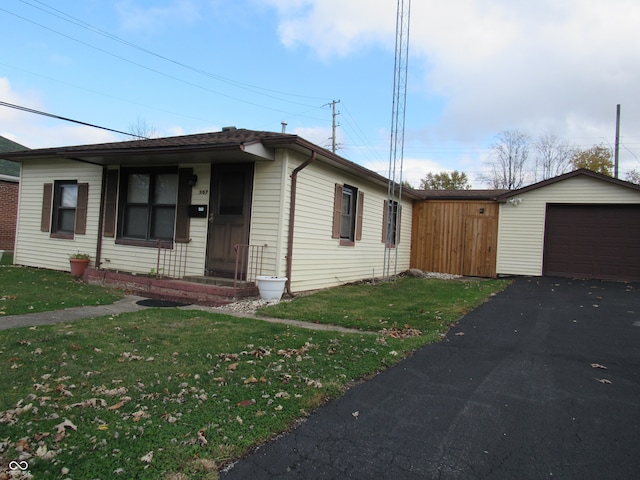 ranch-style home with an outbuilding, a garage, and a front yard