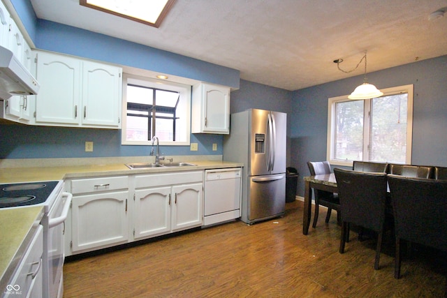 kitchen featuring white cabinets, hanging light fixtures, sink, and white appliances