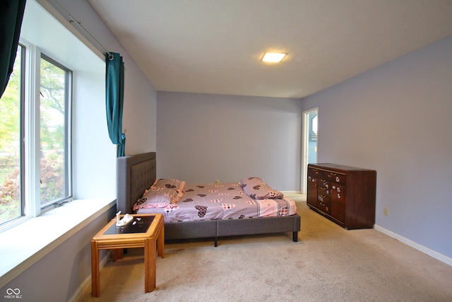 carpeted bedroom featuring multiple windows