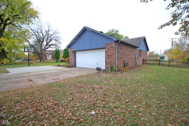 view of property exterior featuring a garage and a yard