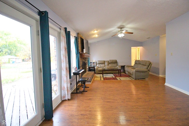 living room featuring hardwood / wood-style floors, plenty of natural light, ceiling fan, and vaulted ceiling