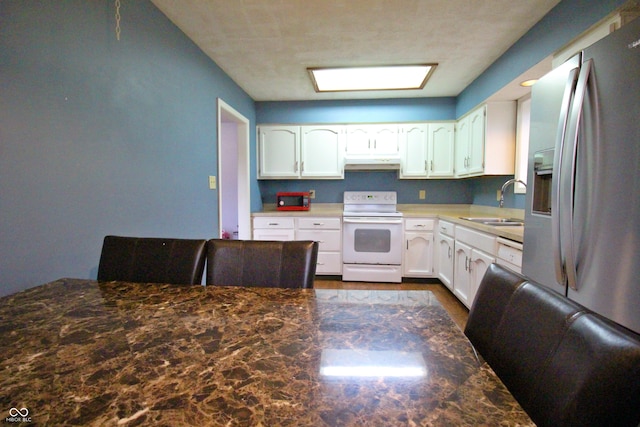 kitchen featuring white cabinetry, stainless steel refrigerator with ice dispenser, sink, and white electric range oven