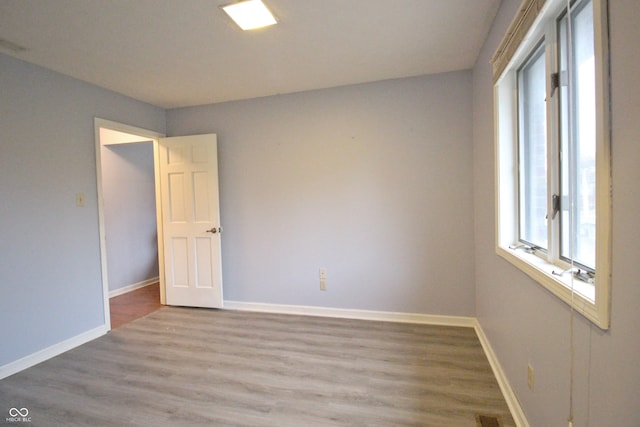 unfurnished room with wood-type flooring