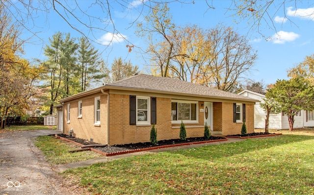 single story home with a front lawn