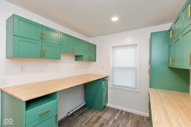 kitchen featuring dark wood-type flooring, green cabinets, and wooden counters