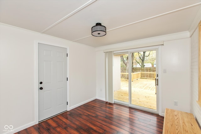 interior space featuring dark wood-type flooring and ornamental molding