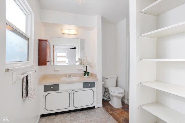 bathroom featuring toilet and vanity