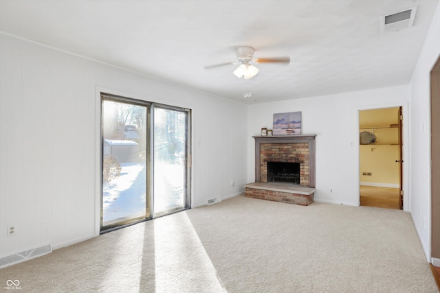 unfurnished living room featuring light carpet, ceiling fan, and a fireplace