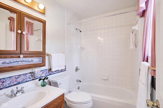 full bathroom with toilet, vanity, and tiled shower / bath