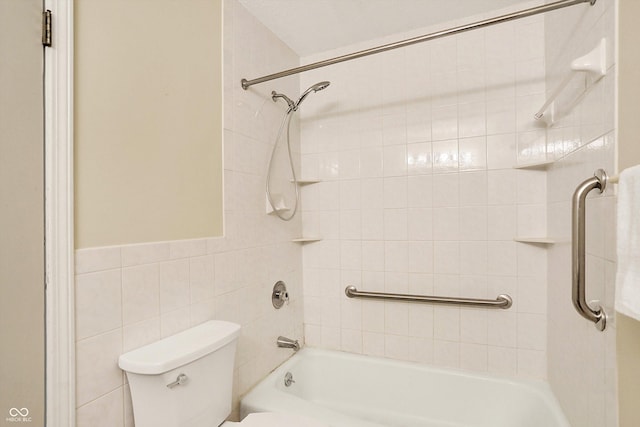 bathroom with toilet, tiled shower / bath combo, and tile walls