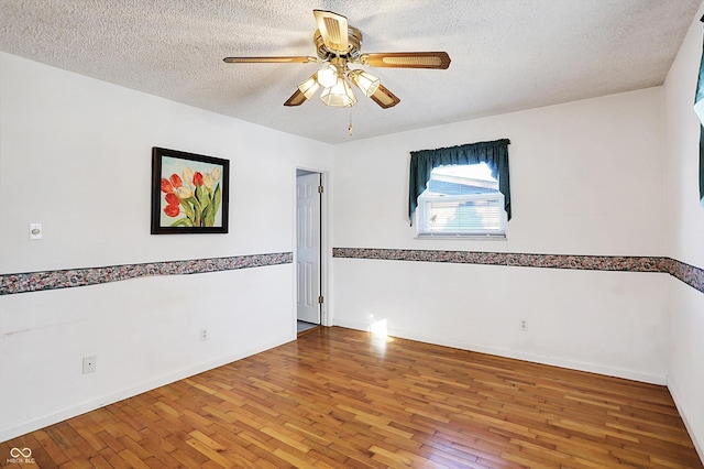 spare room featuring a textured ceiling, ceiling fan, and hardwood / wood-style flooring