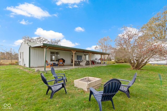 rear view of house featuring a lawn and a patio