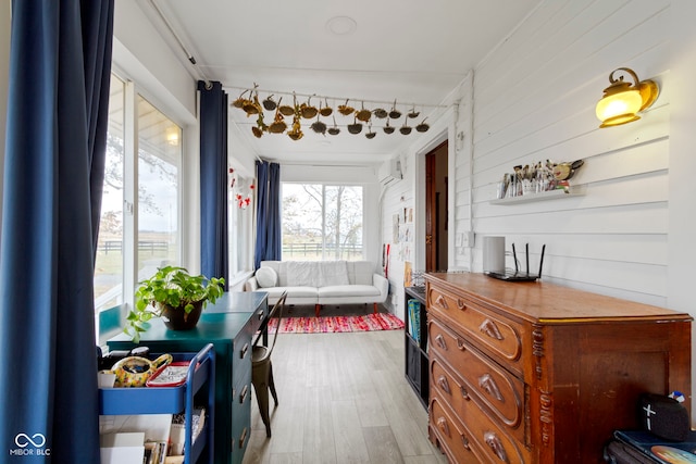 interior space with wood walls and light hardwood / wood-style floors