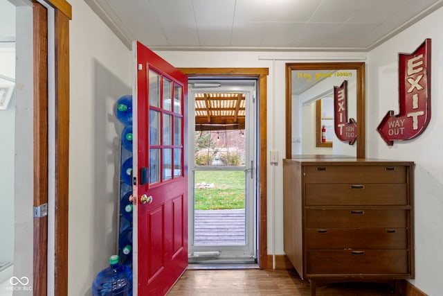 entryway featuring crown molding and wood-type flooring