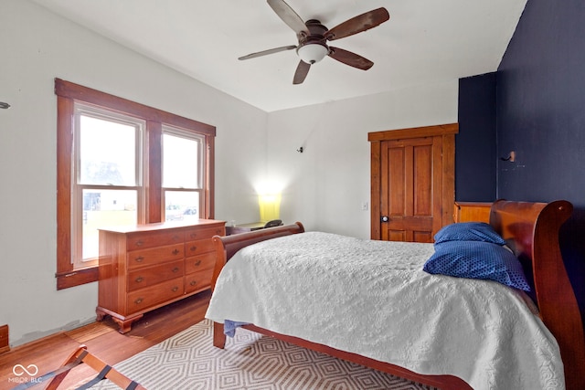 bedroom with ceiling fan and light hardwood / wood-style flooring