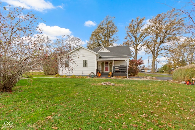 rear view of property featuring a lawn