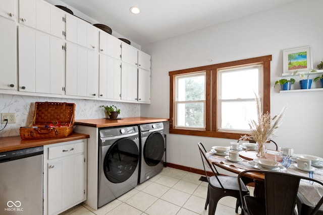 laundry area with washer and dryer and light tile patterned floors