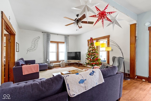 living room featuring ceiling fan and hardwood / wood-style floors