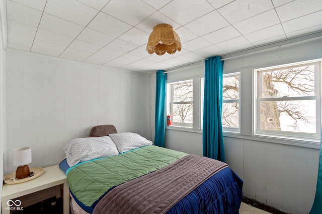 bedroom with wooden walls