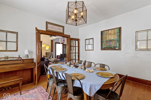 dining room featuring a chandelier, french doors, and light hardwood / wood-style flooring