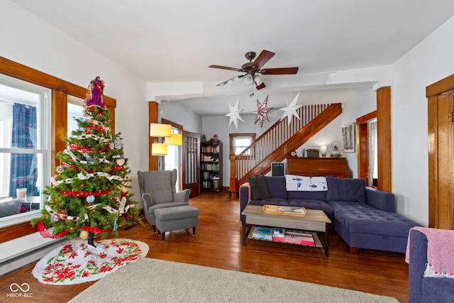 living room featuring ceiling fan and hardwood / wood-style flooring