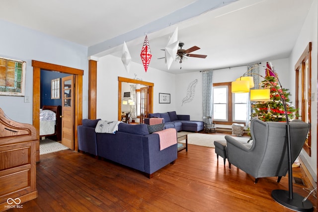 living room featuring beamed ceiling, ceiling fan, and dark hardwood / wood-style flooring