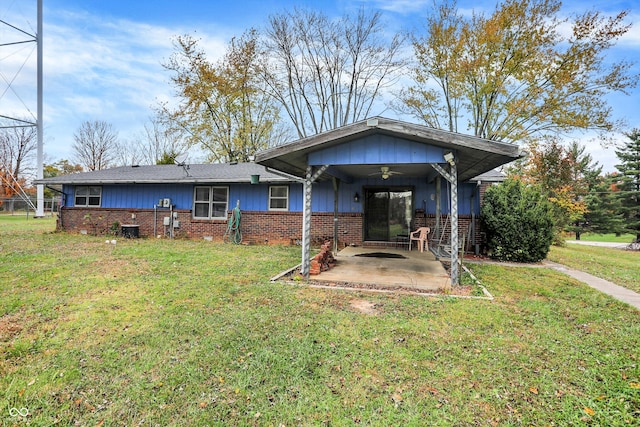 back of property featuring a lawn