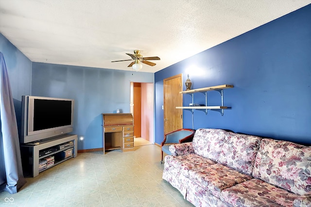 living room with a textured ceiling and ceiling fan