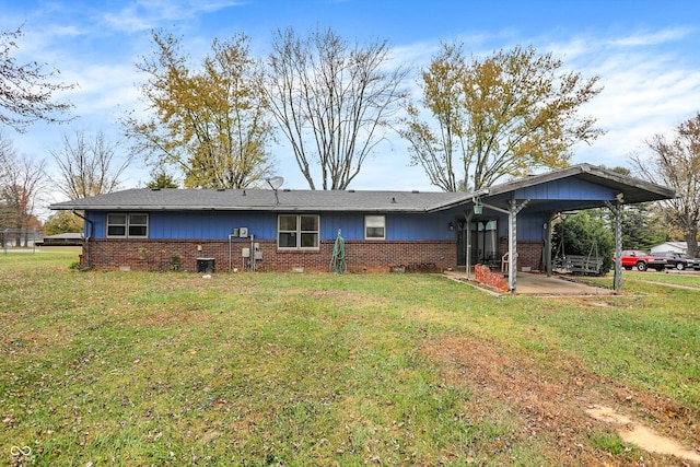 back of house with a lawn