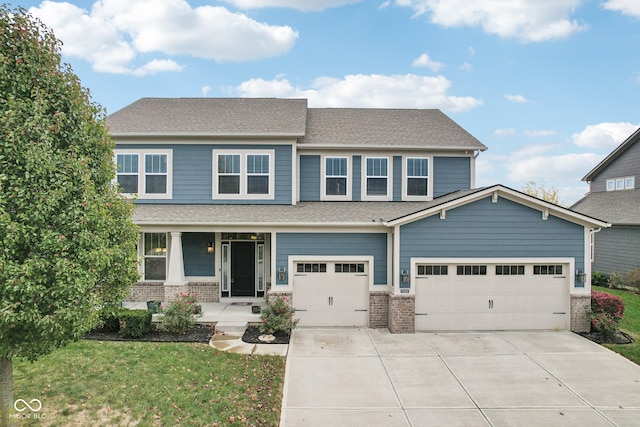 craftsman house featuring covered porch, a garage, and a front lawn