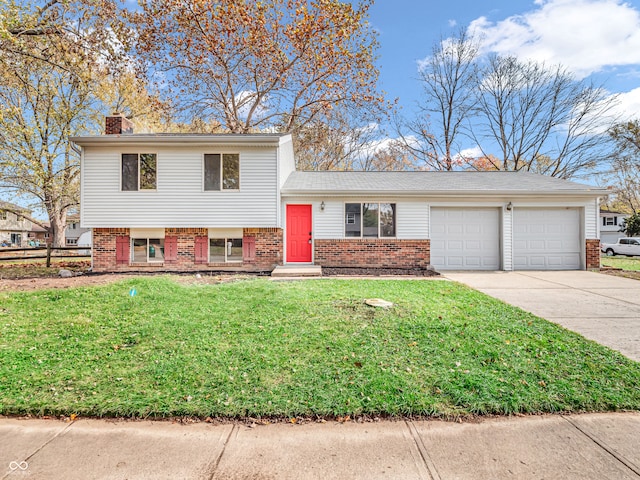 tri-level home with a garage and a front yard