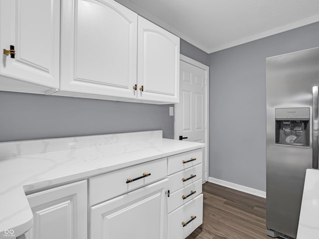 kitchen featuring dark hardwood / wood-style flooring, white cabinetry, stainless steel refrigerator with ice dispenser, and light stone counters