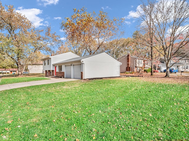 view of home's exterior with a garage and a lawn