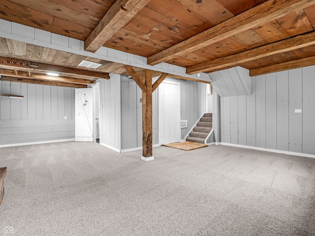 basement featuring wood walls, wood ceiling, and carpet floors