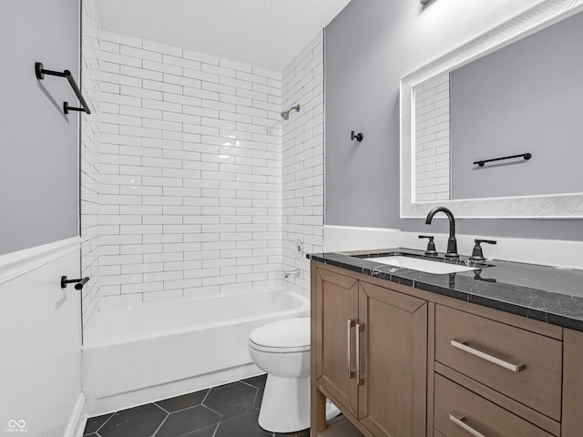 full bathroom with vanity, a textured ceiling, tile patterned flooring, toilet, and tiled shower / bath