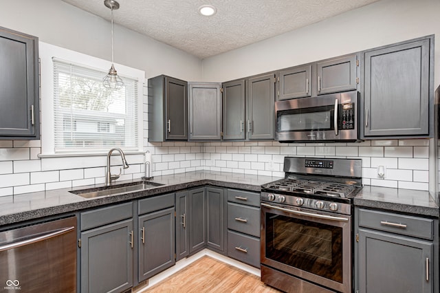 kitchen featuring gray cabinetry, appliances with stainless steel finishes, and sink