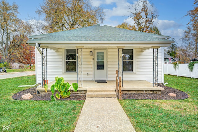 bungalow-style home with a front lawn and covered porch