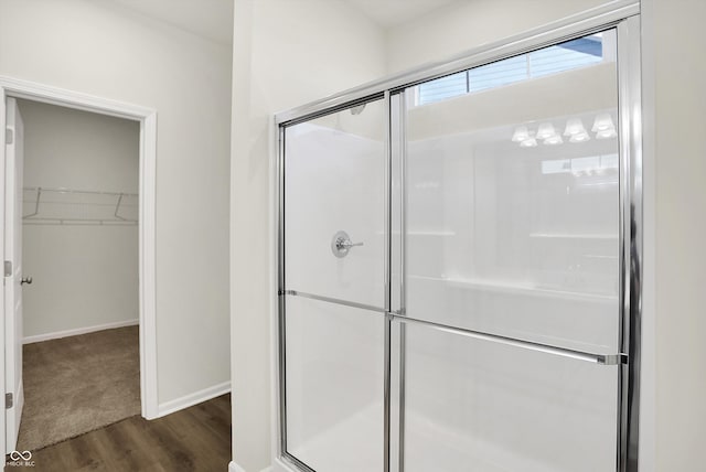 bathroom with walk in shower and hardwood / wood-style flooring