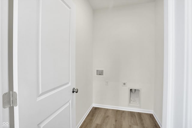 laundry area with hookup for a washing machine, light wood-type flooring, and electric dryer hookup