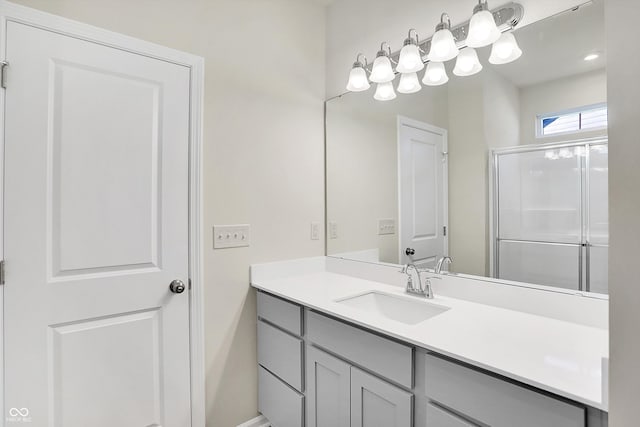 bathroom with walk in shower and vanity