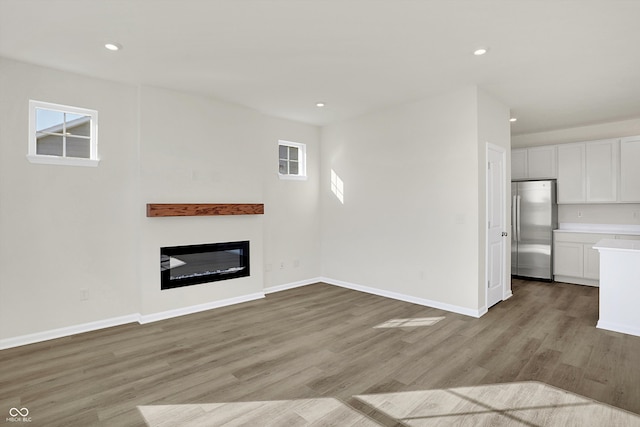 unfurnished living room with light hardwood / wood-style flooring