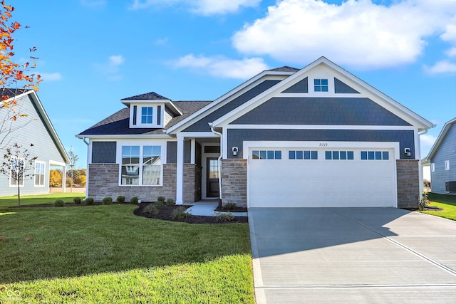 craftsman-style home featuring a garage and a front yard