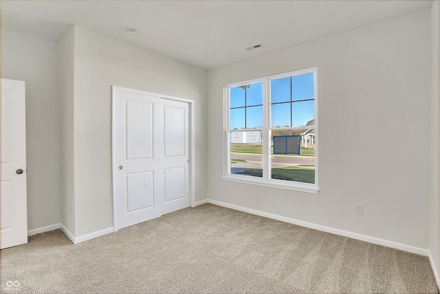 unfurnished bedroom featuring carpet flooring and a closet