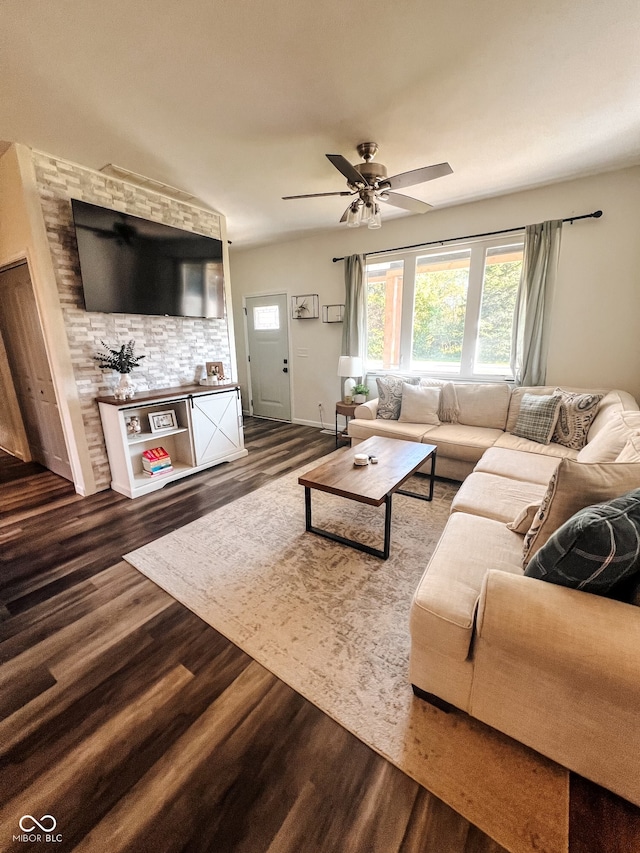 living room featuring ceiling fan and dark hardwood / wood-style floors