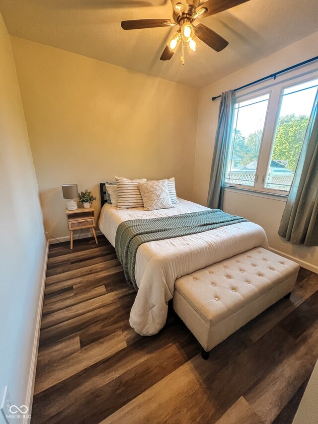 bedroom with ceiling fan and dark hardwood / wood-style flooring