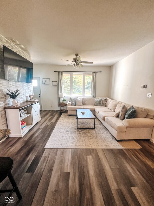 living room with ceiling fan and dark hardwood / wood-style floors